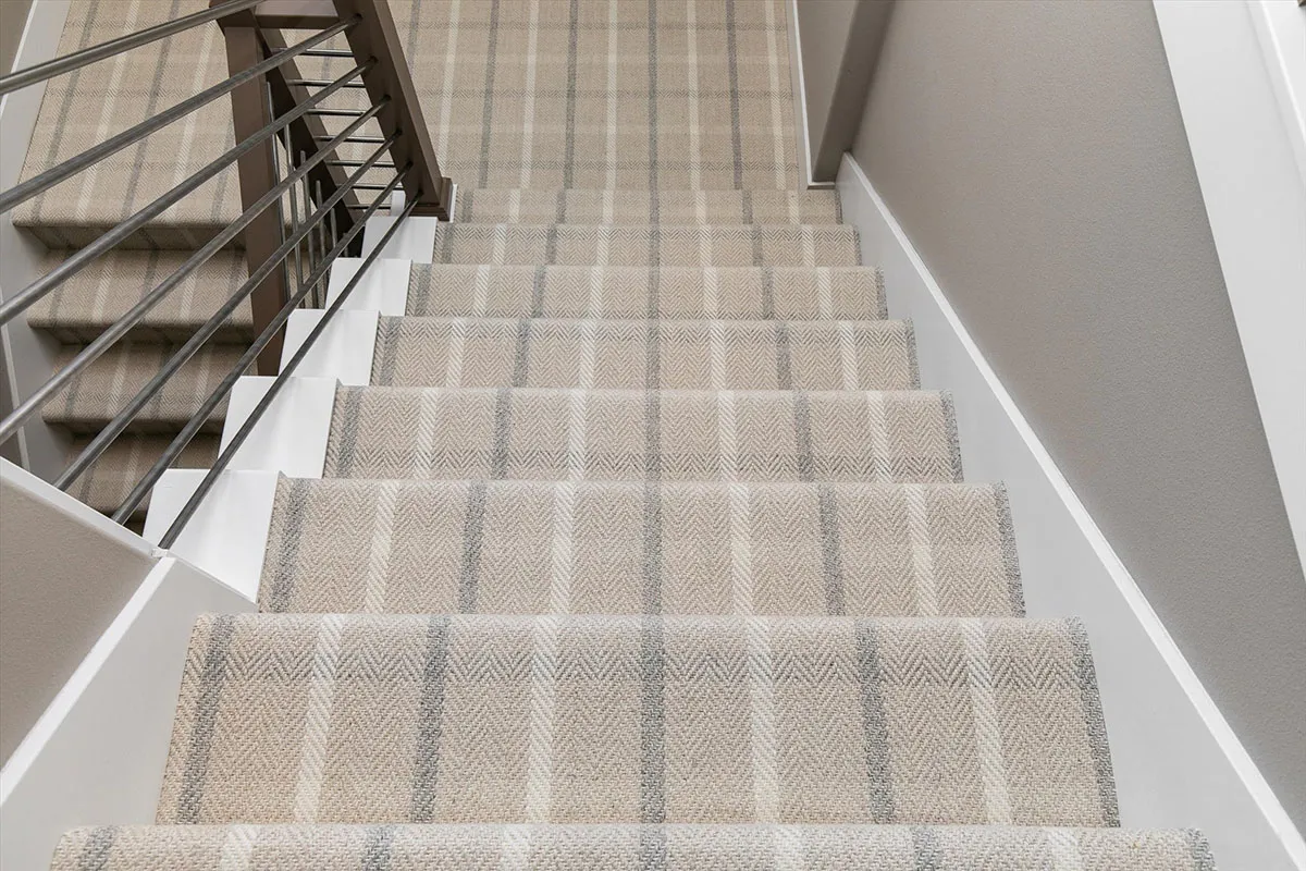 Patterned carpeted stair runner closeup 